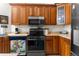 Functional kitchen space boasting wood cabinetry, modern appliances, and a clean, organized layout for cooking at 14145 Citrus Way, Brooksville, FL 34601