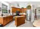 Spacious kitchen with wooden cabinetry, stainless steel appliances, and ample counter space for meal preparation at 14145 Citrus Way, Brooksville, FL 34601