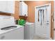 Well-organized laundry room with washer, dryer, storage cabinets, and extra storage at 14145 Citrus Way, Brooksville, FL 34601