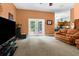 Spacious living room boasts comfortable seating, a large television, and french doors leading to an outdoor area at 14145 Citrus Way, Brooksville, FL 34601