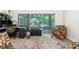 Bright living room with a slider to the patio overlooking lush landscaping bringing the outdoors in at 14145 Citrus Way, Brooksville, FL 34601