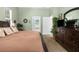 Relaxing main bedroom with dresser, view to en-suite bathroom and muted green paint at 14145 Citrus Way, Brooksville, FL 34601