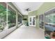 Spacious screened-in porch with tile flooring and views of the landscaped backyard at 14145 Citrus Way, Brooksville, FL 34601