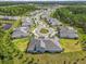 An aerial view of a well-planned community showcases lush landscaping, sidewalks, and cul-de-sac with several homes at 16793 Forge Surf St, Land O Lakes, FL 34638