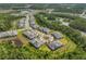 Aerial view of a residential community shows homes with well-maintained lawns nestled among trees and small ponds at 16793 Forge Surf St, Land O Lakes, FL 34638