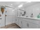 Modern bathroom featuring dual sinks, sleek fixtures, a glass-enclosed shower, and stylish decor at 16793 Forge Surf St, Land O Lakes, FL 34638