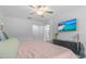 Inviting bedroom with a cozy bed, a TV, and a calming atmosphere with stylish decorations at 16793 Forge Surf St, Land O Lakes, FL 34638