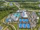 Aerial view of the community center includes a pool, tennis courts, and lush landscaping providing recreational options at 16793 Forge Surf St, Land O Lakes, FL 34638