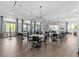 Spacious dining room with modern light fixtures, tables, and large windows at 16793 Forge Surf St, Land O Lakes, FL 34638