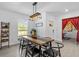 Dining area featuring a rustic table with seating, open to the living room and kitchen at 16793 Forge Surf St, Land O Lakes, FL 34638