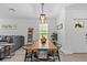 Dining room with a modern farmhouse-style table and chairs, open to the living area at 16793 Forge Surf St, Land O Lakes, FL 34638