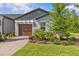 Charming single-story home featuring a manicured lawn, neat landscaping, and an attached garage at 16793 Forge Surf St, Land O Lakes, FL 34638