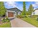 View of a well-maintained home featuring a brick driveway and lush green landscaping at 16793 Forge Surf St, Land O Lakes, FL 34638
