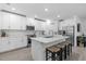 Bright kitchen featuring stainless steel appliances, quartz countertops and an island with bar seating at 16793 Forge Surf St, Land O Lakes, FL 34638