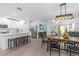 Open concept featuring kitchen with white cabinets, island seating, and adjoining dining and living spaces at 16793 Forge Surf St, Land O Lakes, FL 34638