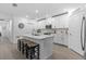 Well-lit kitchen featuring white cabinets, a quartz island and stainless steel appliances at 16793 Forge Surf St, Land O Lakes, FL 34638