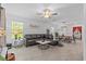 Spacious living room features modern decor and an open layout connecting the dining area at 16793 Forge Surf St, Land O Lakes, FL 34638