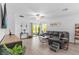 Bright living area with a comfortable sectional sofa and sliding glass doors to outdoor space at 16793 Forge Surf St, Land O Lakes, FL 34638