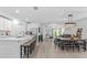 Bright, open-concept kitchen and living area featuring modern furnishings and flooring at 16793 Forge Surf St, Land O Lakes, FL 34638