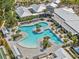 Overhead shot of community pool with tropical landscaping and a seating area for residents in a common area at 16793 Forge Surf St, Land O Lakes, FL 34638