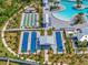 Aerial view of bocce ball and shuffleboard courts adjacent to pool and sunbathing area provides recreational opportunities at 16793 Forge Surf St, Land O Lakes, FL 34638