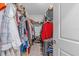 Spacious walk-in closet with ample storage, well-organized shelving, and neatly arranged clothing and accessories at 16793 Forge Surf St, Land O Lakes, FL 34638
