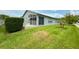The backyard features a screened-in porch and a small palm tree at 18109 Webster Grove Dr, Hudson, FL 34667