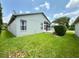 A cozy screened in porch overlooks the home's backyard at 18109 Webster Grove Dr, Hudson, FL 34667