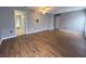 Large bedroom featuring hardwood floors, neutral walls and walk in to main bath at 18109 Webster Grove Dr, Hudson, FL 34667