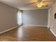 Well-lit bedroom with neutral walls, ceiling fan, and wood-look flooring at 18109 Webster Grove Dr, Hudson, FL 34667