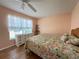 Comfortable bedroom featuring a floral comforter and light-colored walls at 18109 Webster Grove Dr, Hudson, FL 34667