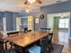 This dining room boasts hardwood floors, a rustic dining table, and easy access to the living room and other areas at 18109 Webster Grove Dr, Hudson, FL 34667