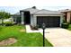 Charming single-story home featuring a well-manicured lawn and a two-car garage, creating a welcoming curb appeal at 18109 Webster Grove Dr, Hudson, FL 34667
