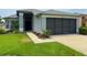 Charming single-story home featuring a screened garage and beautifully landscaped front yard at 18109 Webster Grove Dr, Hudson, FL 34667