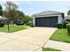 Single-story home showing the driveway and screened garage at 18109 Webster Grove Dr, Hudson, FL 34667