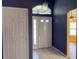 Bright foyer featuring tile flooring, a white door, and a transom window above the entryway at 18109 Webster Grove Dr, Hudson, FL 34667