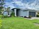 Well-maintained single-story house with a manicured lawn and a two-car garage at 18109 Webster Grove Dr, Hudson, FL 34667