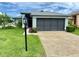 Lovely single-story home featuring a two-car garage, manicured lawn, and a welcoming entrance at 18109 Webster Grove Dr, Hudson, FL 34667