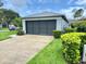 Spacious two-car garage with a clean driveway and landscaping, adding curb appeal at 18109 Webster Grove Dr, Hudson, FL 34667