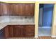 The kitchen features dark wood cabinets with granite countertops and tiled backsplash at 18109 Webster Grove Dr, Hudson, FL 34667