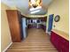 A wide-angle view of an updated kitchen and breakfast nook with wood floors at 18109 Webster Grove Dr, Hudson, FL 34667