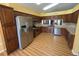 An updated kitchen features wood cabinets, granite countertops, and stainless steel appliances at 18109 Webster Grove Dr, Hudson, FL 34667