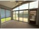 Relaxing sunroom with screened windows, ceiling fan, and views of the yard at 18109 Webster Grove Dr, Hudson, FL 34667