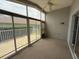 Sunroom featuring screened windows and a ceiling fan for comfortable outdoor living at 18109 Webster Grove Dr, Hudson, FL 34667