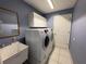 Laundry room with washer, dryer, sink, and cabinet, making chores a breeze at 18109 Webster Grove Dr, Hudson, FL 34667