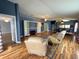 This living area has hardwood floors, a comfortable seating arrangement, custom built-in shelving, and an open layout at 18109 Webster Grove Dr, Hudson, FL 34667
