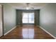 Spacious living room featuring neutral colored walls with wood-look floors at 18109 Webster Grove Dr, Hudson, FL 34667