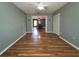 Open-plan living room features neutral walls, wood-look floors, and a view to the dining area at 18109 Webster Grove Dr, Hudson, FL 34667