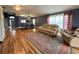 Spacious living room with hardwood floors, neutral paint, and plenty of natural light at 18109 Webster Grove Dr, Hudson, FL 34667
