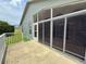 Patio features a screened-in sunroom and a small green yard at 18109 Webster Grove Dr, Hudson, FL 34667